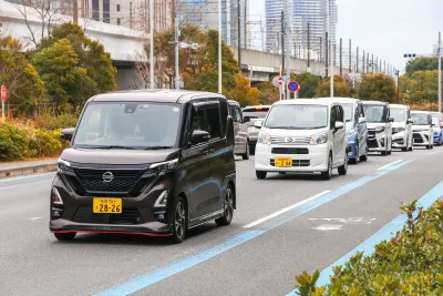 Row of tiny Japanese kei cars on street in Tokyo.
