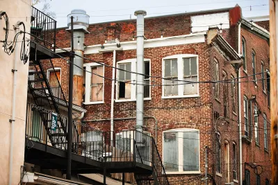 REd brick apartment buildings from back with fire escapes in Philadelphia, PA.