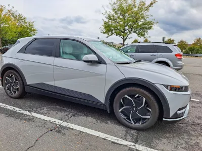 Grey electric SUV parked in parking lot.