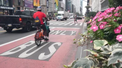 A bicyclist rides in a bus lane in NYC