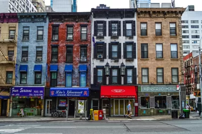 Multicolored four-story New York City buildings with storefronts on ground floor