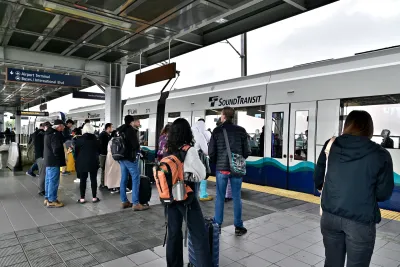 Crowd waiting on platform as Sound Transit train pulls in in Seattle, Washington.