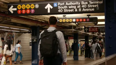 People navigate an underground subway system in New York City.