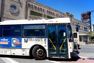White and blue NJ Transit bus in front of Newark Penn Station in Newark, New Jersey.