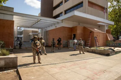 Armed military personnel guarding ICE builing in downtown Portland, Oregon.