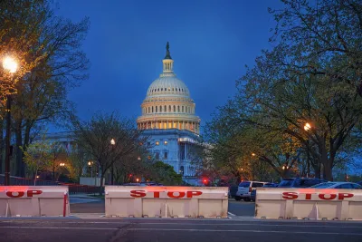 US Capitol dome in Washingotn DC at night with chain link fence set up to prevent trespassing.