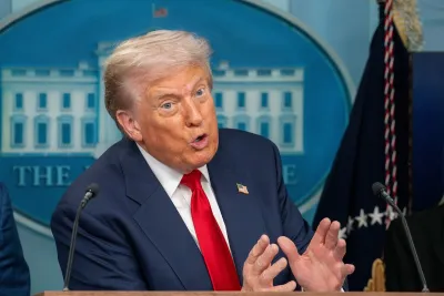 Trump gestured behind a podium. His hands are held close together.