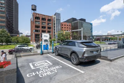 Silver SUV parked at outdoor EV charging station in Detroit, Michigan.