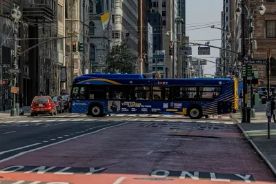 Bus passing across Madison Avenue in New York City.