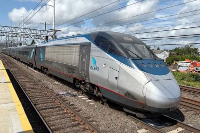 Silver Amtrak Acela train on track.