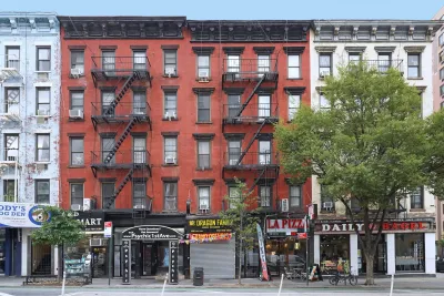 Brick New York City apartment buildings with commercial businesses on ground floor.