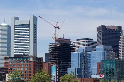 Buildings in downtown Boston with large red construction crane.