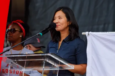 Boston Mayor Michelle Wu stands at lectern during speech.