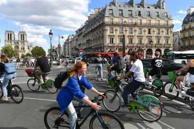 people riding bikes in street in Paris, France.