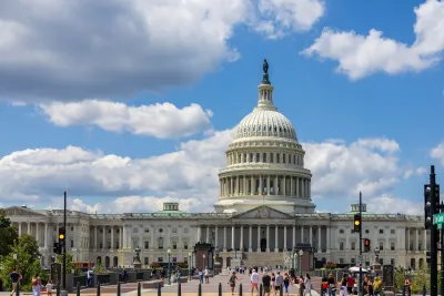 US Capitol dome in Washington DC with people walking around in front.