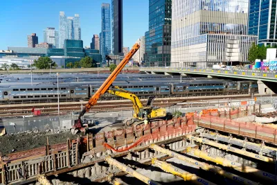 Large orange crane at construction site for Gateway Project tunnel.