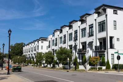 White three-story apartment building in Durham, North Carolina.