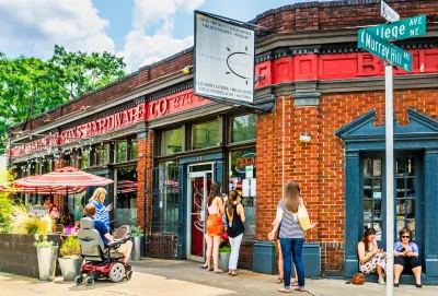 Street with small rick commercial buildings and many pedestrians in Atlanta, Georgia.