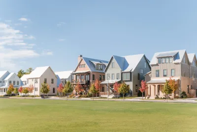 Row of modern two-story homes with large grass lawn in front against pale blue sky in Oklahoma City, Oklahoma.