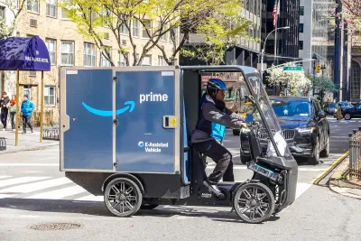 A blue Amazon three-wheeled electric delivery cargo bike in New York City.