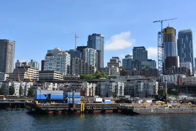 Downtown Seattle as seen from water with construction cranes visible.