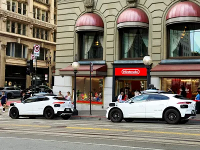Two Waymo robotaxis parked in San Francisco