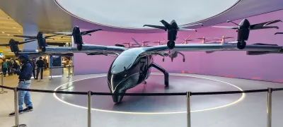 One of Archer Aviations air taxis. it has four small propellers and a sleek black build.