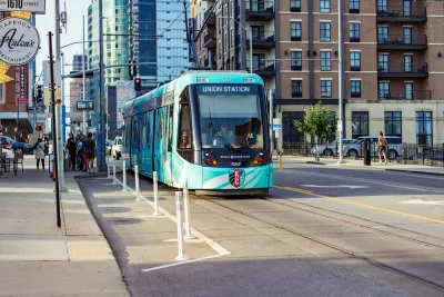 Teal Kansas City streetcar on downtown street.