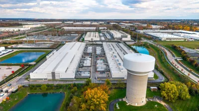 Aerial of data center with large water tower in foreground in rural Ohio.