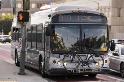 Silver Los Angeles Metro transit bus with bike mounted infront rack.