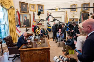 President Donald Trump sitting at desk in Oval Office during presser announcing tariffs. 