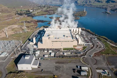 Aerial drone picture of a massive hyperscale Google data center campus with cooling steam rising from industrial cooling systems, located along the Columbia River.