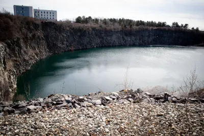 A quarry in Maine, filled with water and surrounded by stones.