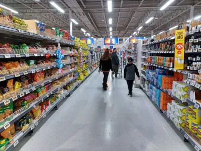 People walking down aisle of grocery store in Toronto, Canada.