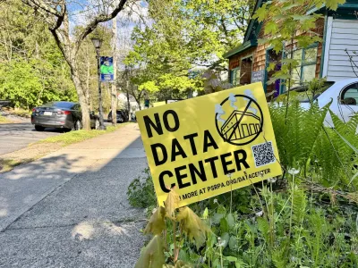 A yellow yard sign with "NO DATA CENTER" in black text.