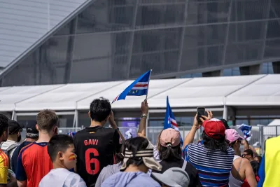 Crowd of soccer fans outside Atlanta stadium celebrating 2026 World Cup.