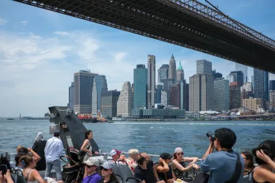 A group of people on a ferry in NYC, with the harbor and skyline visible.