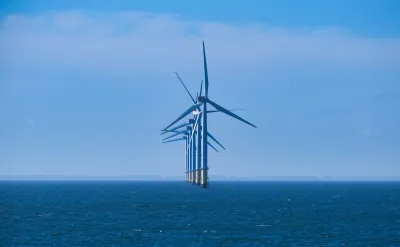 A line of offshore windmills.