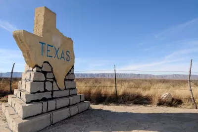 Texas-shaped road sign with TEXAS text on rural roadside