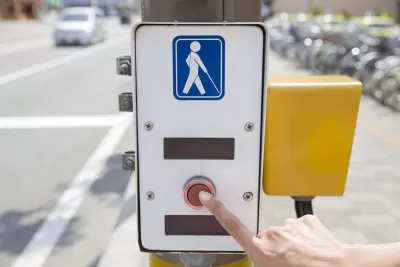 Crosswalk button with illustration of visually impaired pedestrian