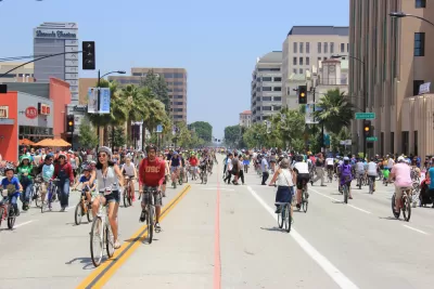 Many people on bikes riding on city street during CicLAvia event in Pasadena, California