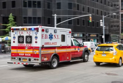 Ambulance driving down New York City street