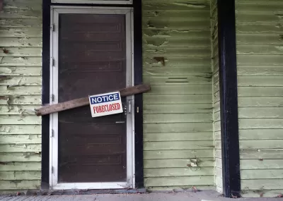 Vacant home with foreclosure sign.