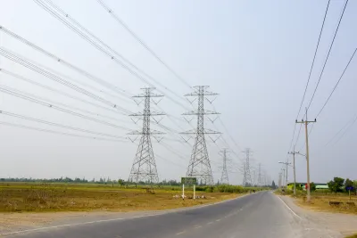 High voltage transmission lines alongside a road.