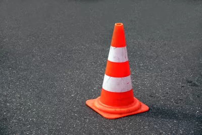Orange traffic cone on black asphalt