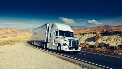 Diesel big rig truck on California road with mountains in background