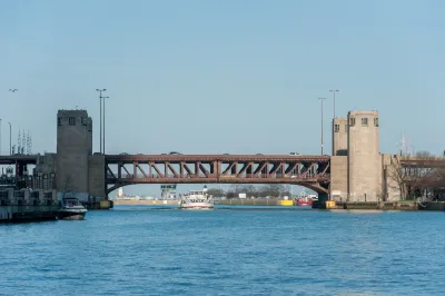 The Lake Shore Drive Bridge with a boat passing under it.