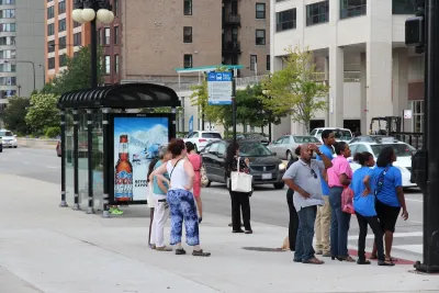 People waiting at a Chicago bus stop.
