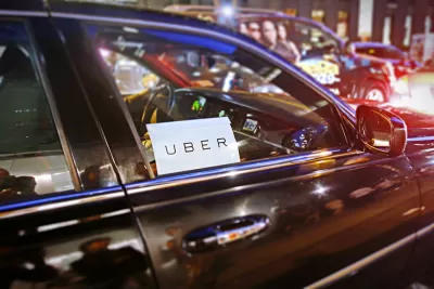 Close-up of car windshield with Uber sticker on city street