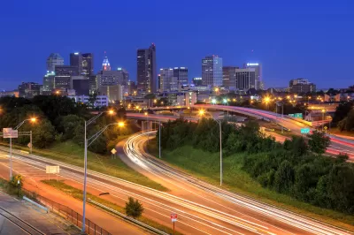 Nighttime view of downtown Columbus, Ohio over freeways with fast-moving traffic